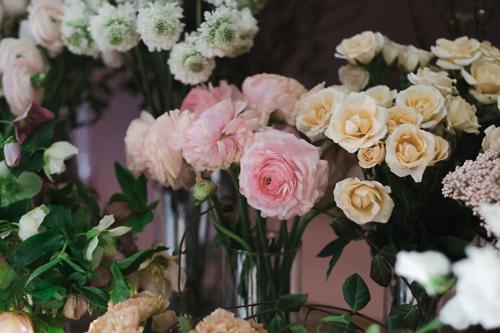 Flower Delivery.  Bouquets of pink, white, and yellow flowers in vases against a blurred background by The Dreamt Garden, Madison AL florist.  Whimsical flower shop in Madison Alabama, serving Huntsville AL.