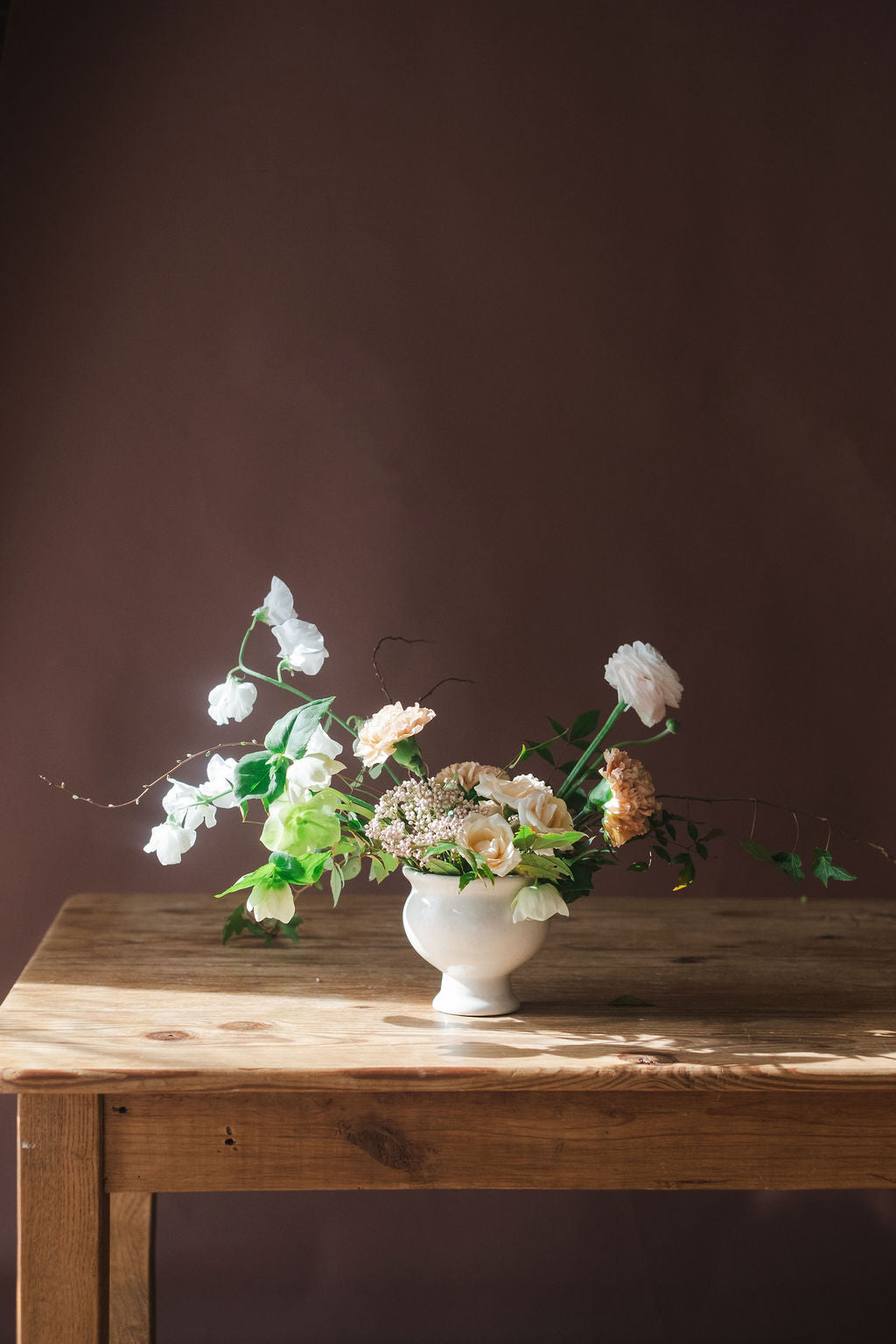 Roses sweet peas ivy spirea ranunculus in compote vase.  Customers order this arrangement from The Dreamt Garden for Corporate Events, Bridal Showers, Baby Showers,  Holiday Flowers, and Sympathy Flowers.  