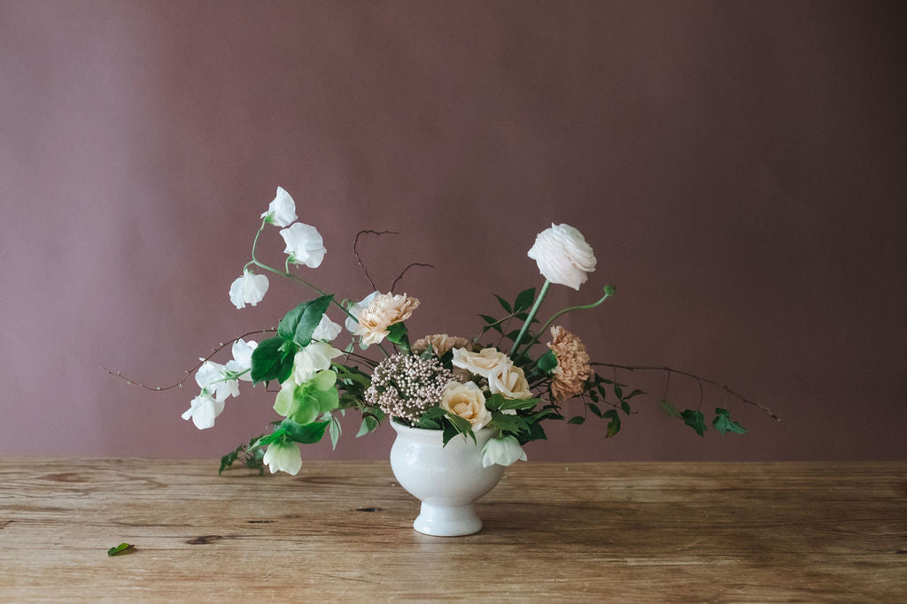Cottage garden flowers including roses, ivy, sweet peas and greenery.  Floral arrangement is used at Corporate Events, Bridal Showers, Baby Showers, and Sympathy Flowers