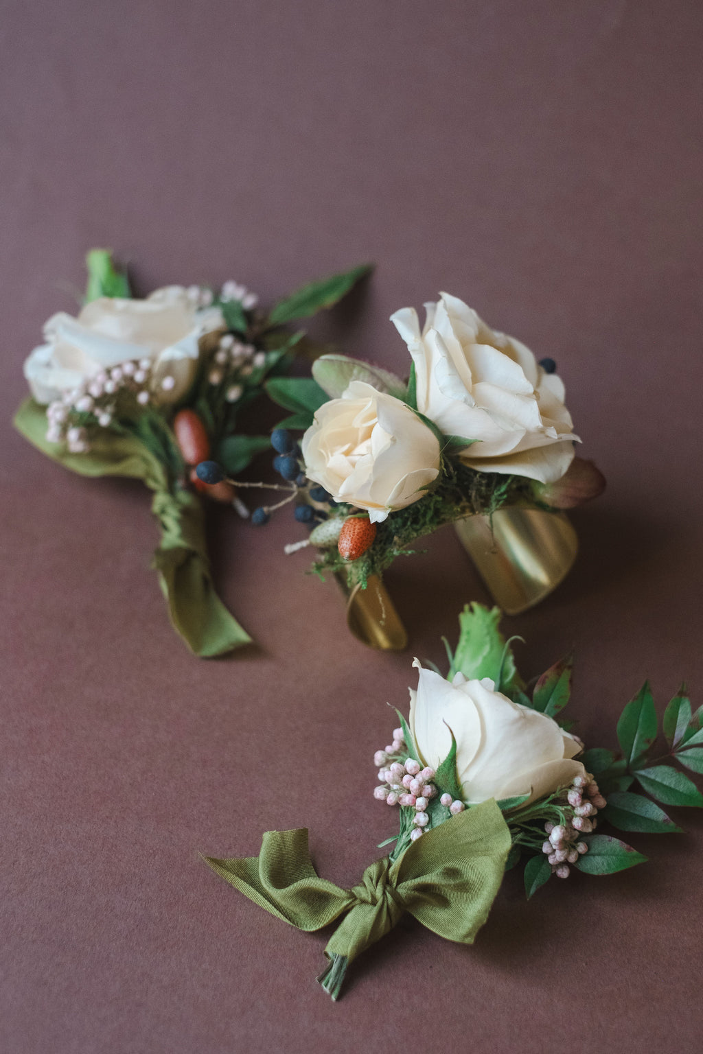 Boutonnieres and corsage with roses and greenery from The Dreamt Garden, a whimsical Flower Shop Madison AL