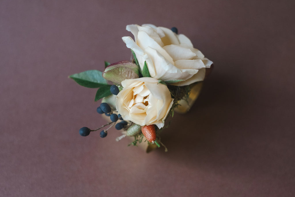 This corsage is made of beautiful flowers artfully arranged on brass bracelet.  The Dreamt Garden specializes in garden style florals for small weddings in Madison Athens and Huntsville AL.