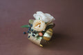 Peach and white flowers on gold bracelet for a la Carte Weddings Madison Huntsville AL.  The Dreamt Garden is a modern retail flower shop in downtown Madison, AL.