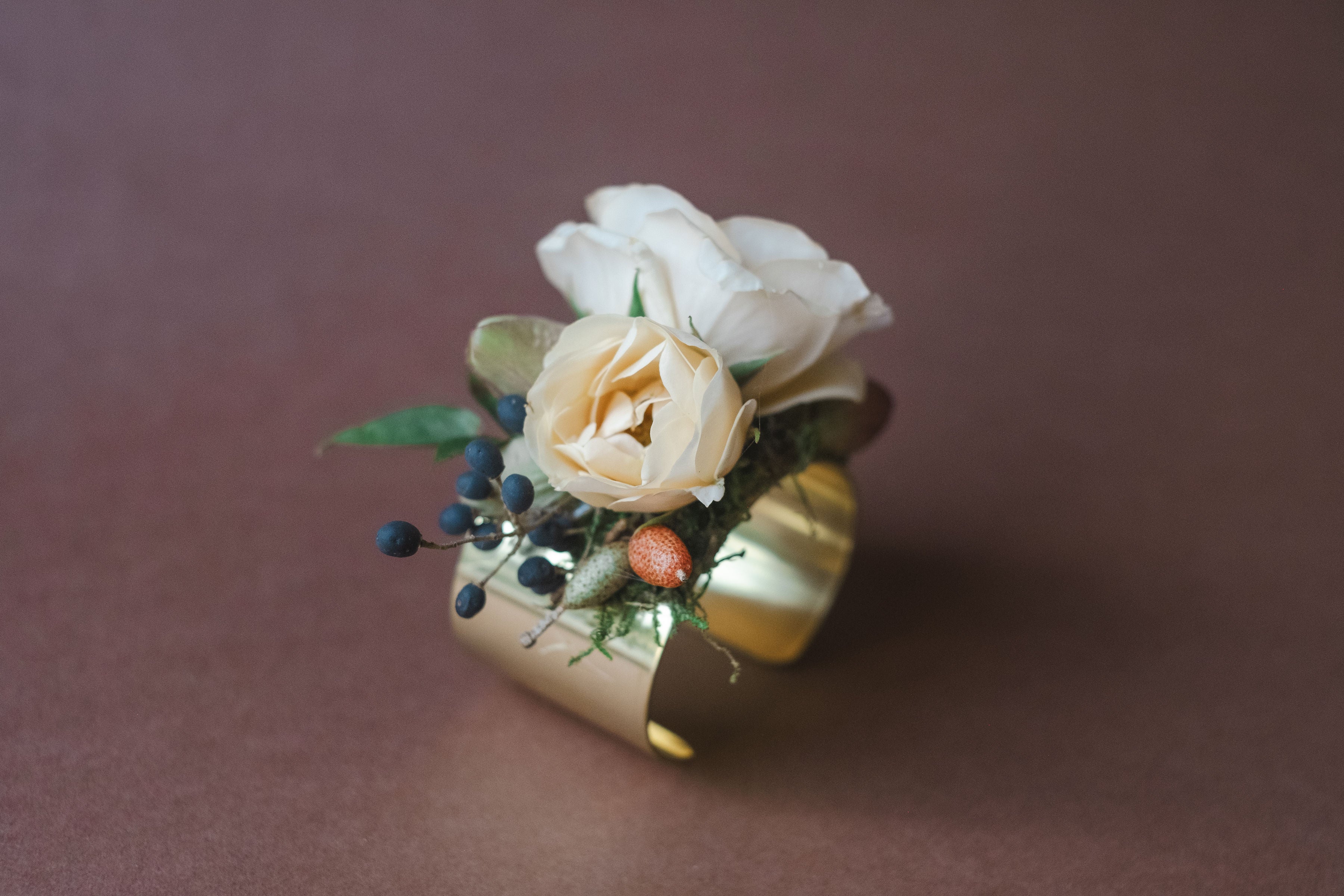 Peach and white flowers on gold bracelet for a la Carte Weddings Madison Huntsville AL.  The Dreamt Garden is a modern retail flower shop in downtown Madison, AL.